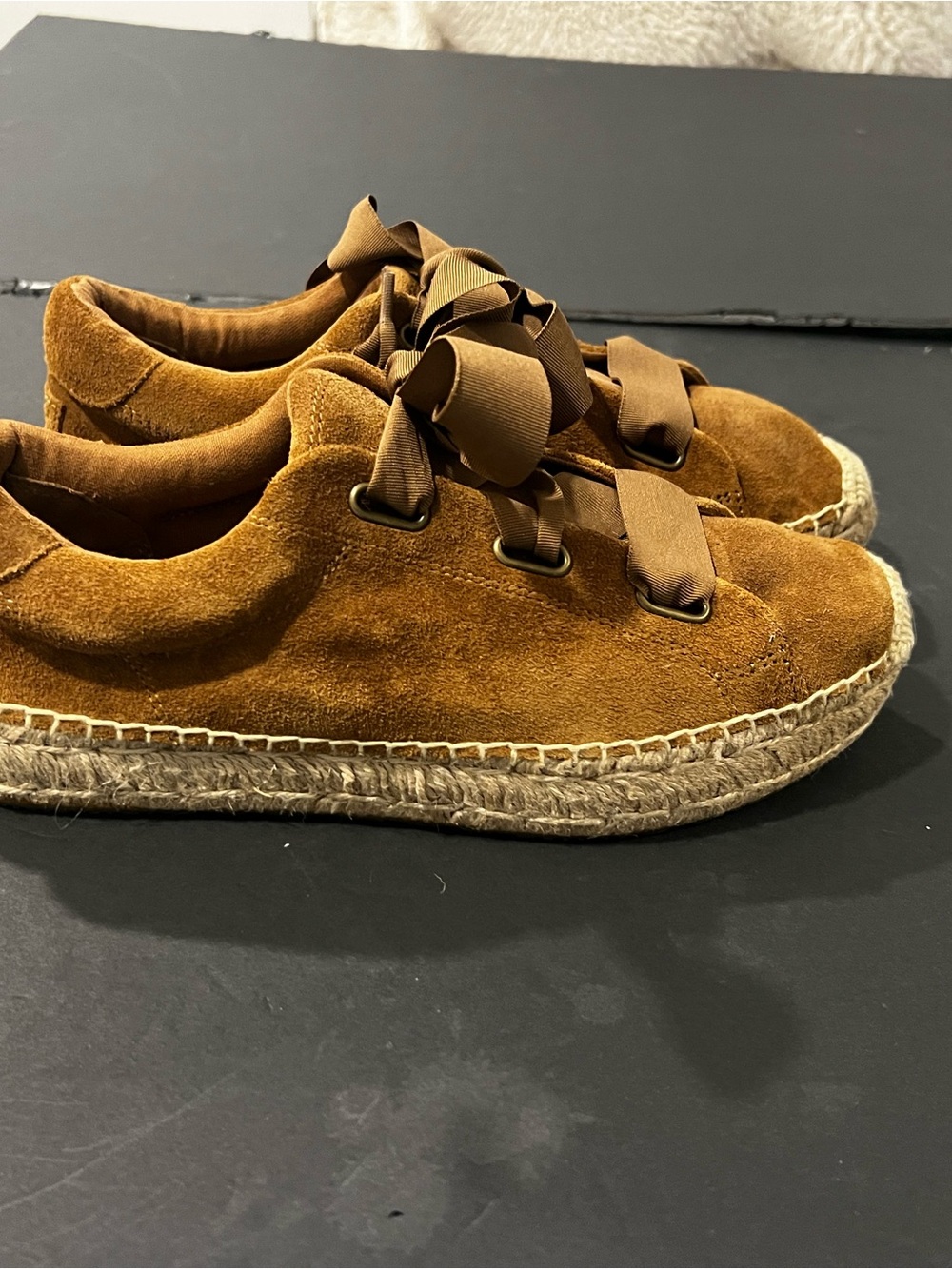 UGG Brianna chestnut suede espadrille sneakers with ribbon lace-up closures.